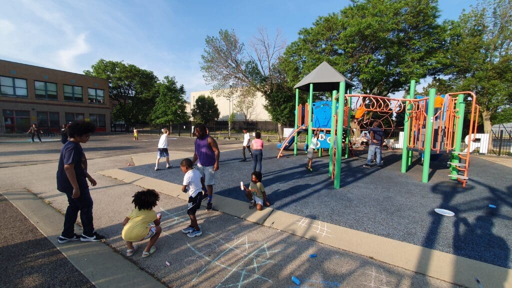 Young people playing on G. R. Elementary's playlot during Playlot nights.