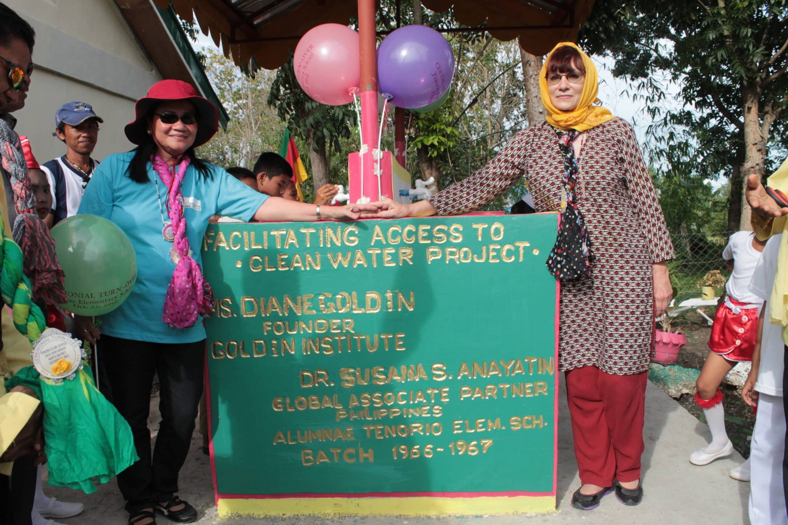Dr. Susana Anayatin and Diane Goldin open the new safe drinking water station at Tenorio Elementary School in Mindanao, Philippines.