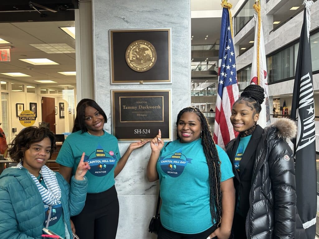 Ladies of Virtue posing in front of Tammy Duckworth's office. 