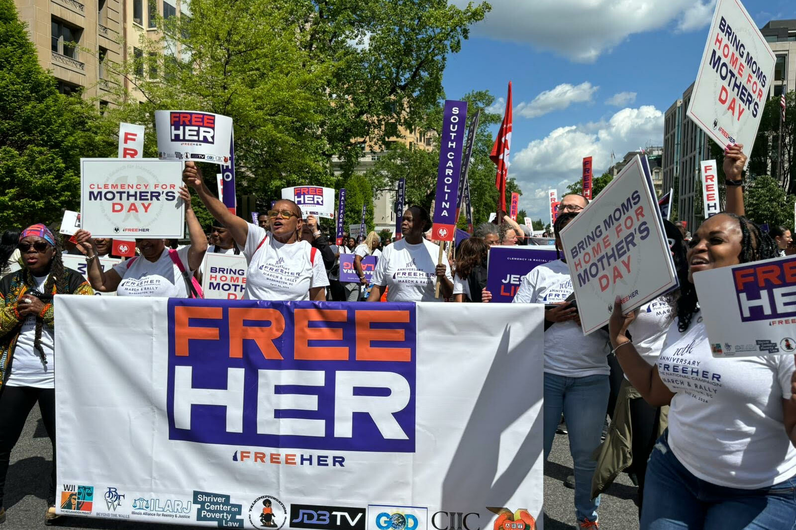 a crowd advocating for clemency at the FreeHer March