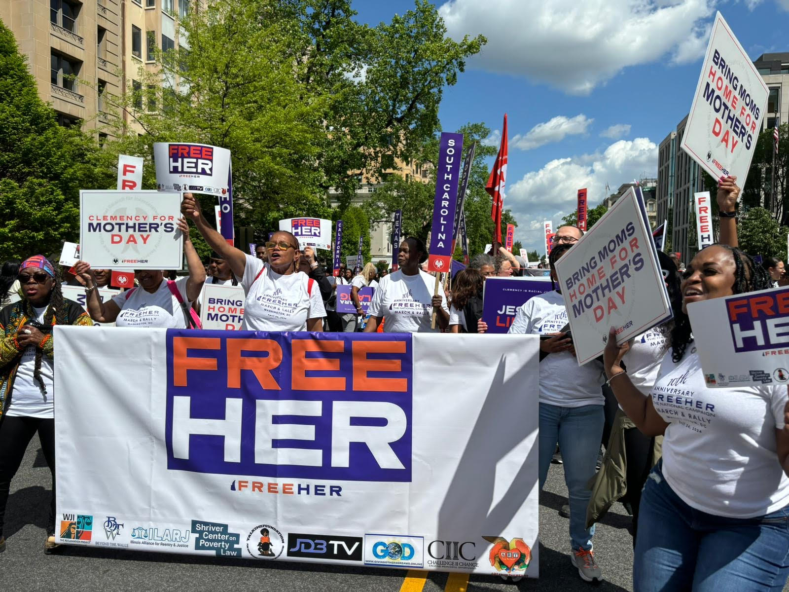 a crowd advocating for clemency at the FreeHer March