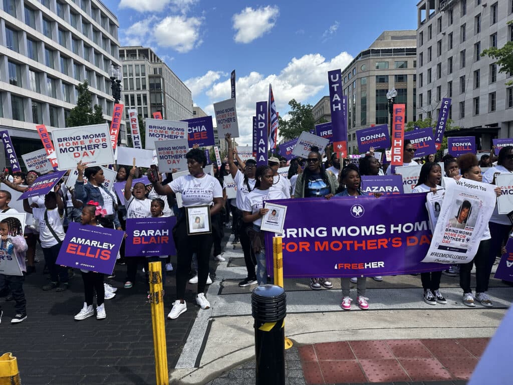 a crowd advocating for clemency at the FreeHer March