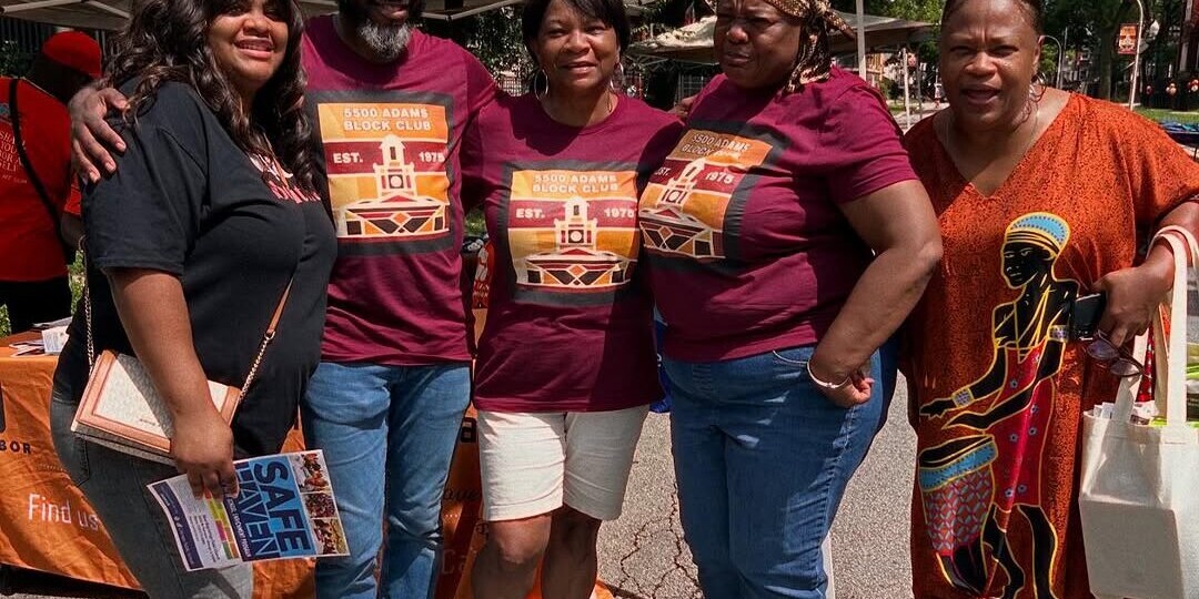 A group of block club volunteers posing at the block party