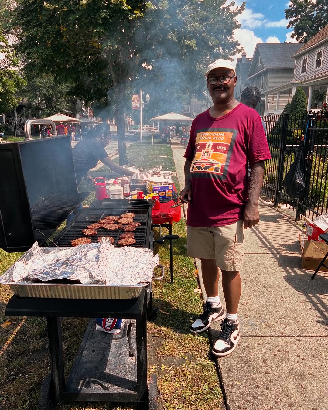 A block club member grilling at the block party