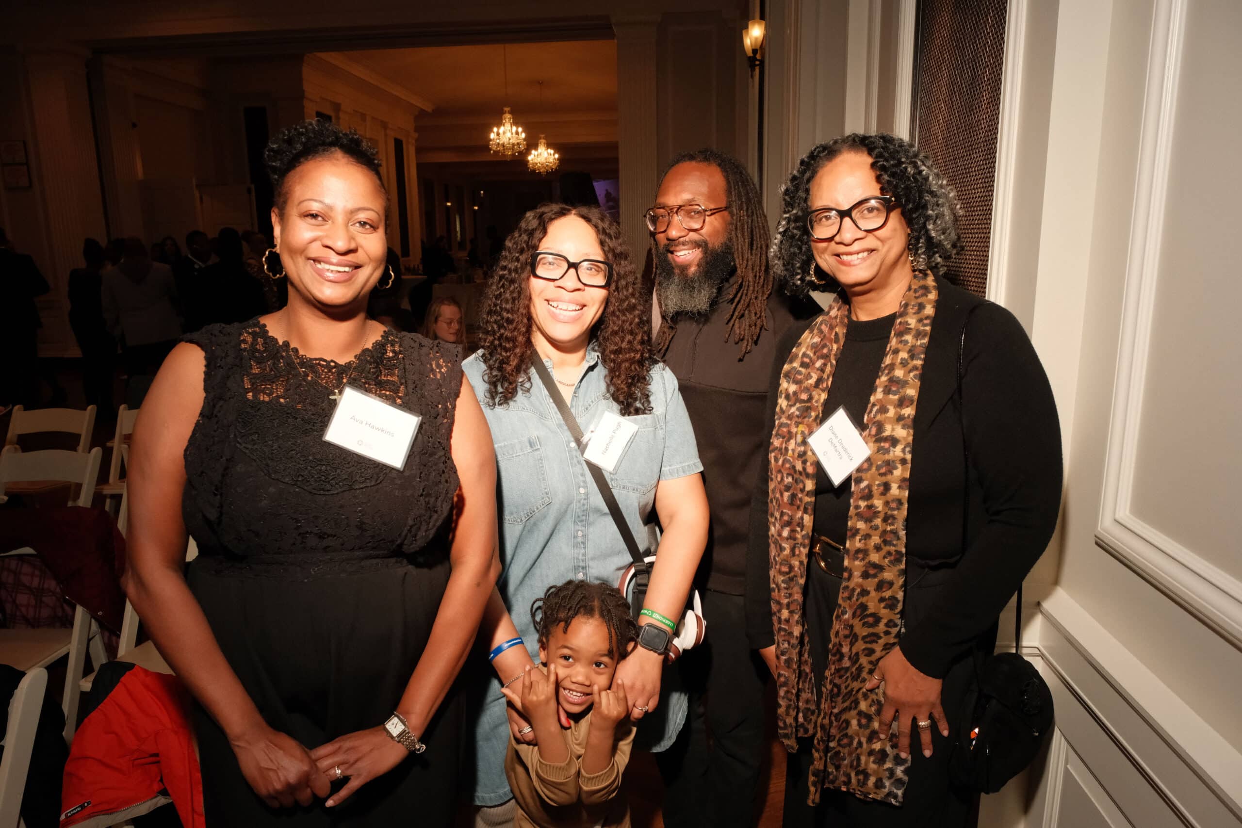 A Group of CHicago Peace fellow graduates and alumni and a child posing for a photo