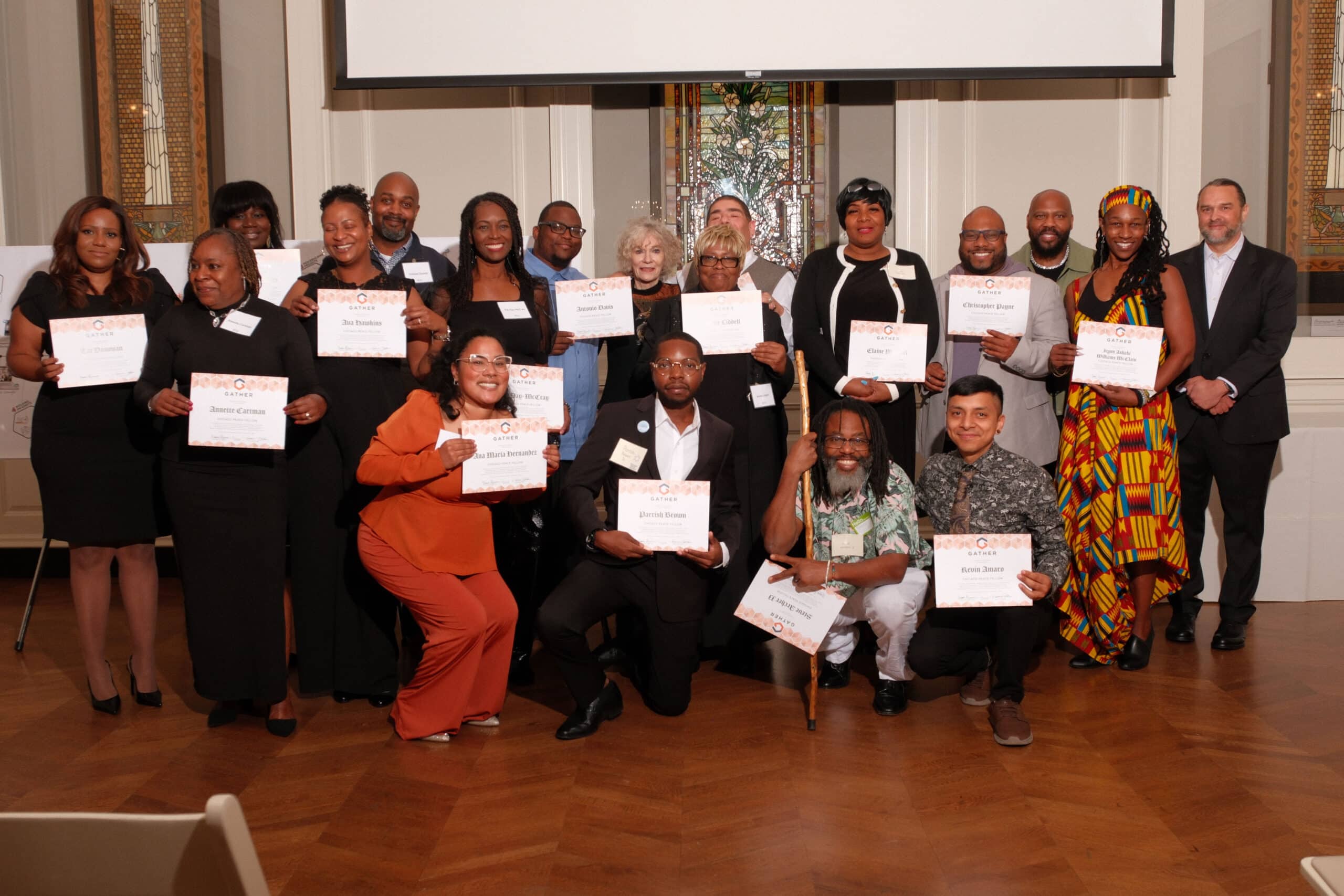 The 2024 Chicago Peace Fellows holding their graduation certificates