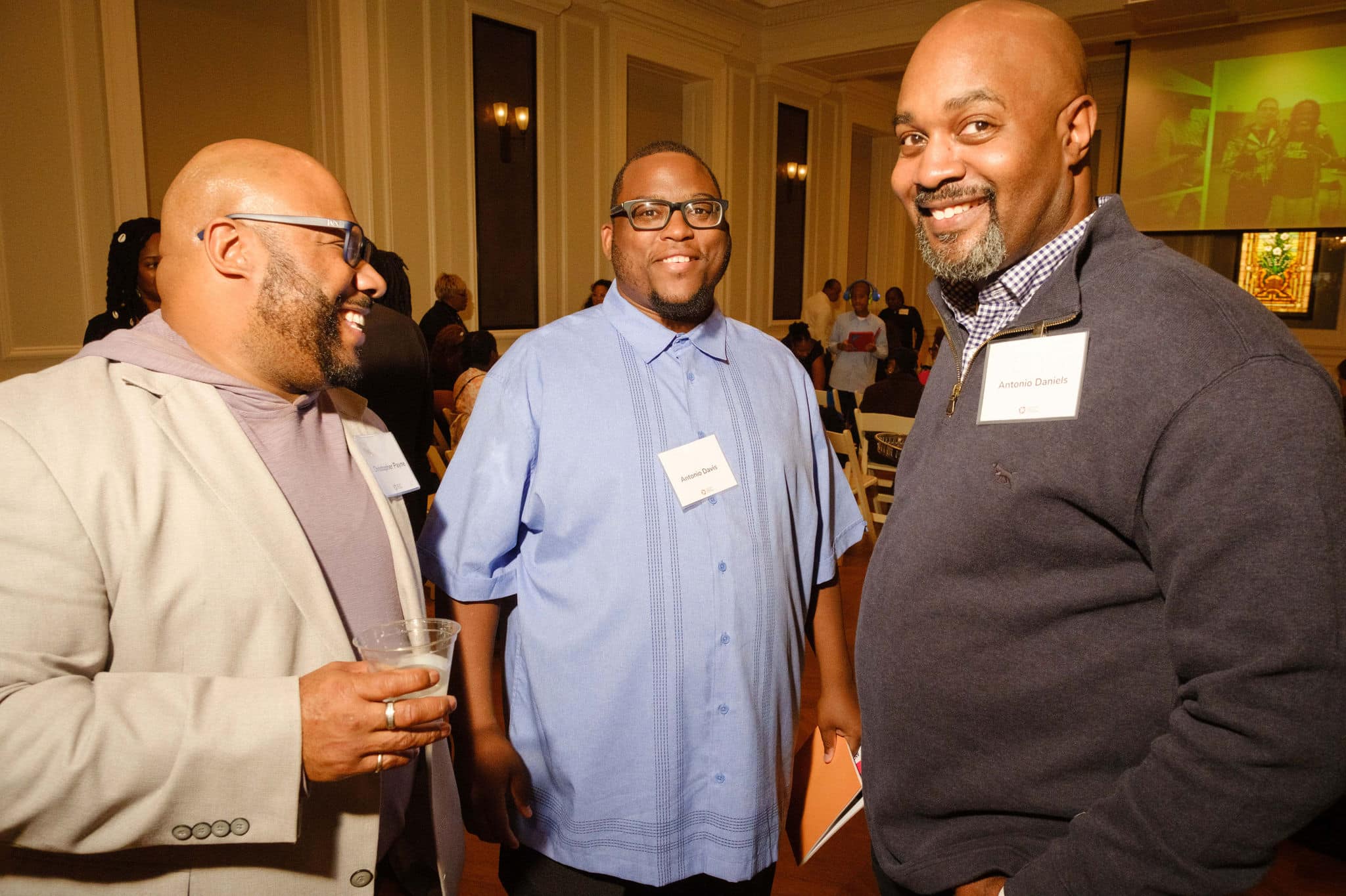 Three members of the Chicago Peace Fellows posing at the reception