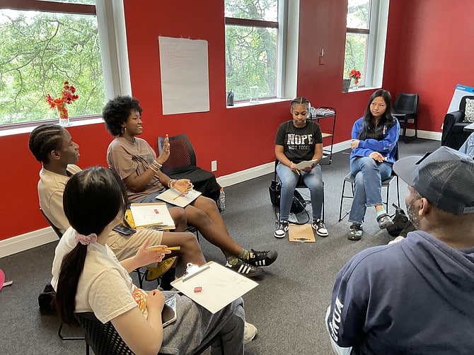 A group of Black and Asian American students sitting in a circle as part of the Racial Healing Collaborative.